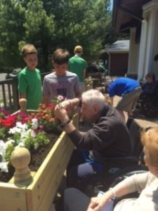 elderly man planting with children