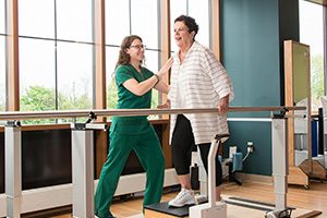 nurse helping patient walk