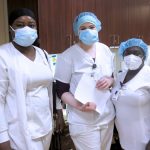 2 women in smocks and masks