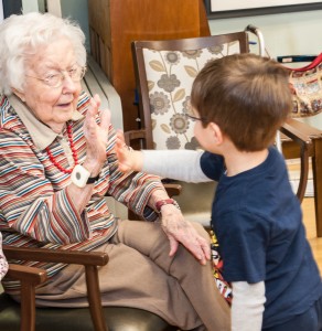 older woman high-fiving young boy