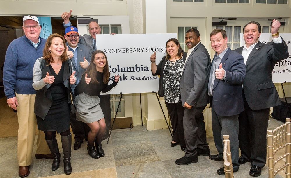 group photo of people with their thumbs up