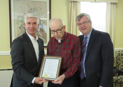 Mayor Kevin Rooney, presenting a proclamation to artist and Hillcrest resident Alban Albert
